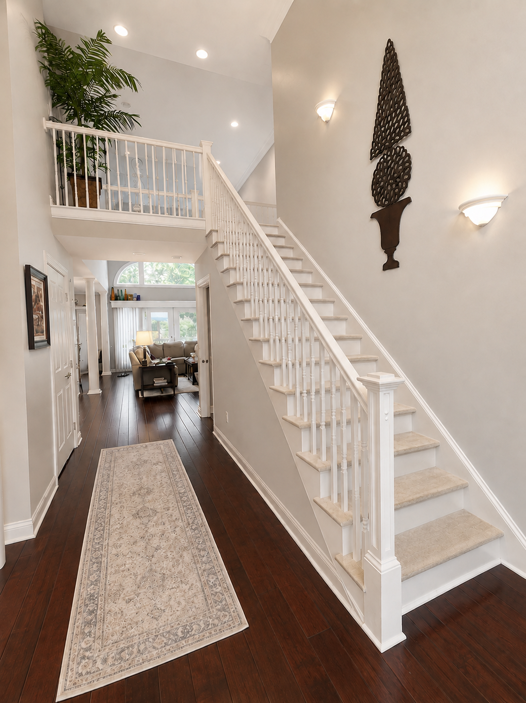 Staircase railing before remodel — original white painted banister and balusters