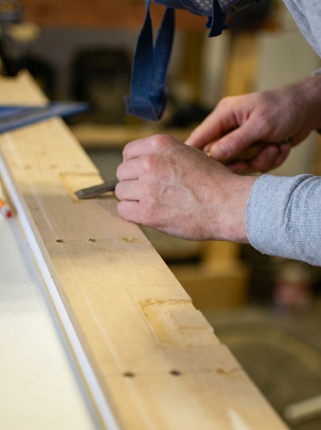 Michael Troutman hand-cutting joinery on a custom woodworking project