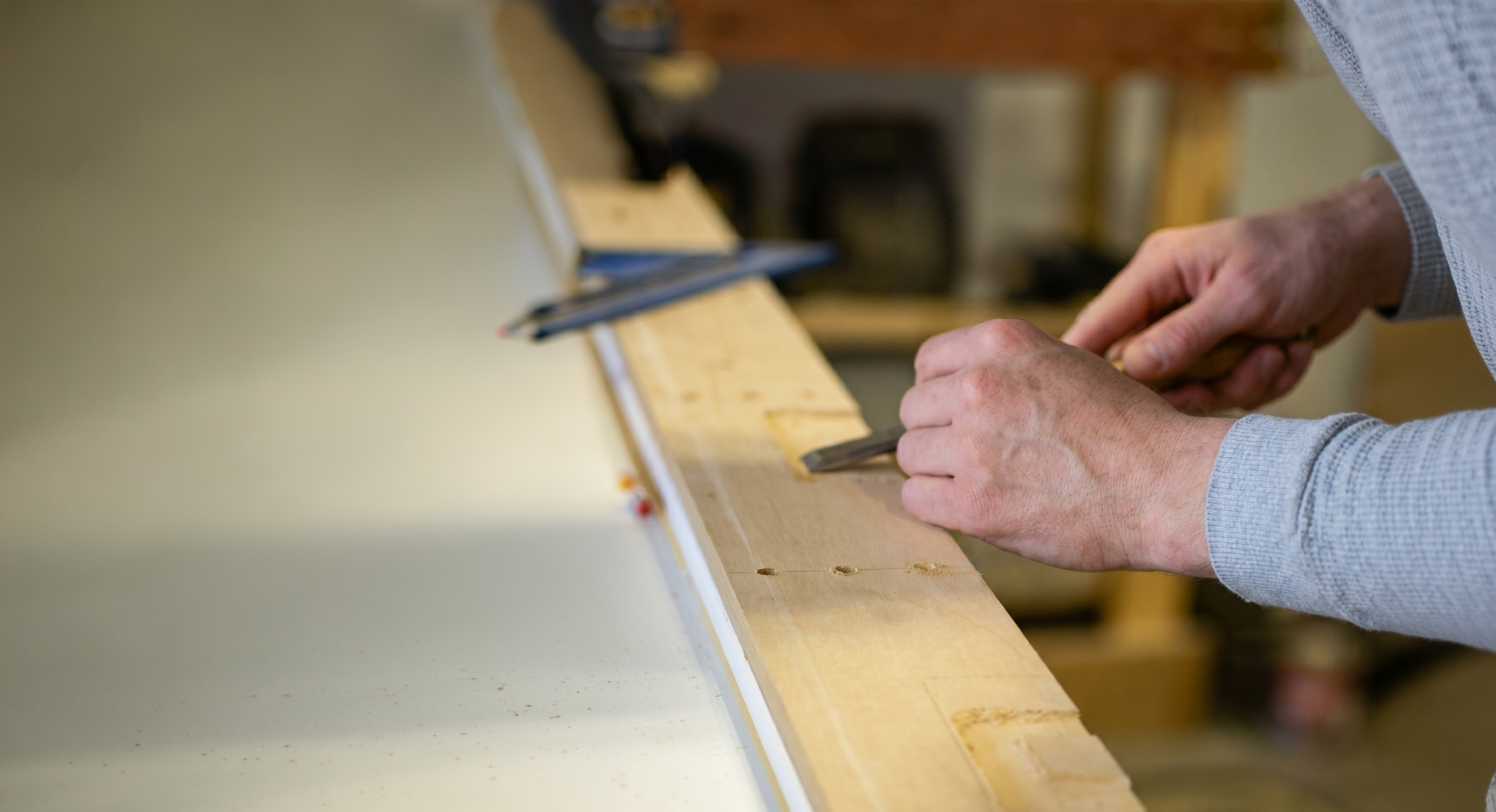 Michael Troutman hand-cutting a mortise with a chisel in his Kentucky woodworking shop