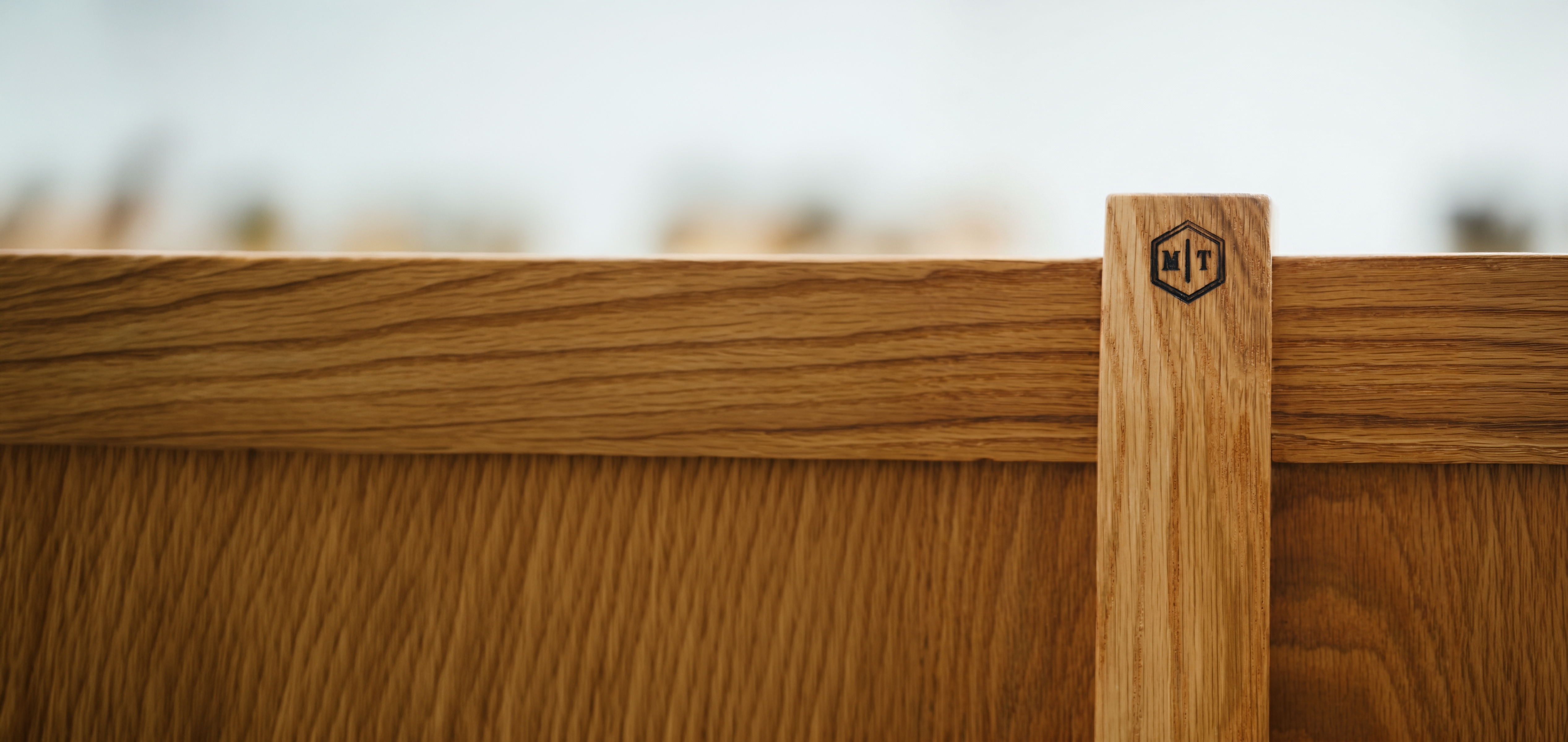 Handcrafted white oak furniture with the Michael Troutman Woodworks maker's mark branded into the wood