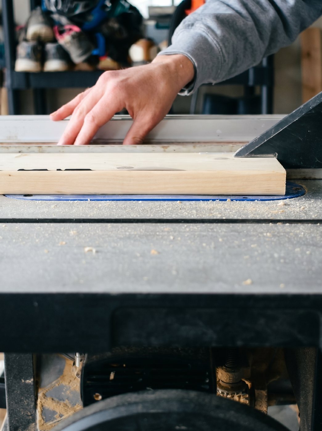 Michael Troutman ripping a board on the table saw in his Kentucky workshop